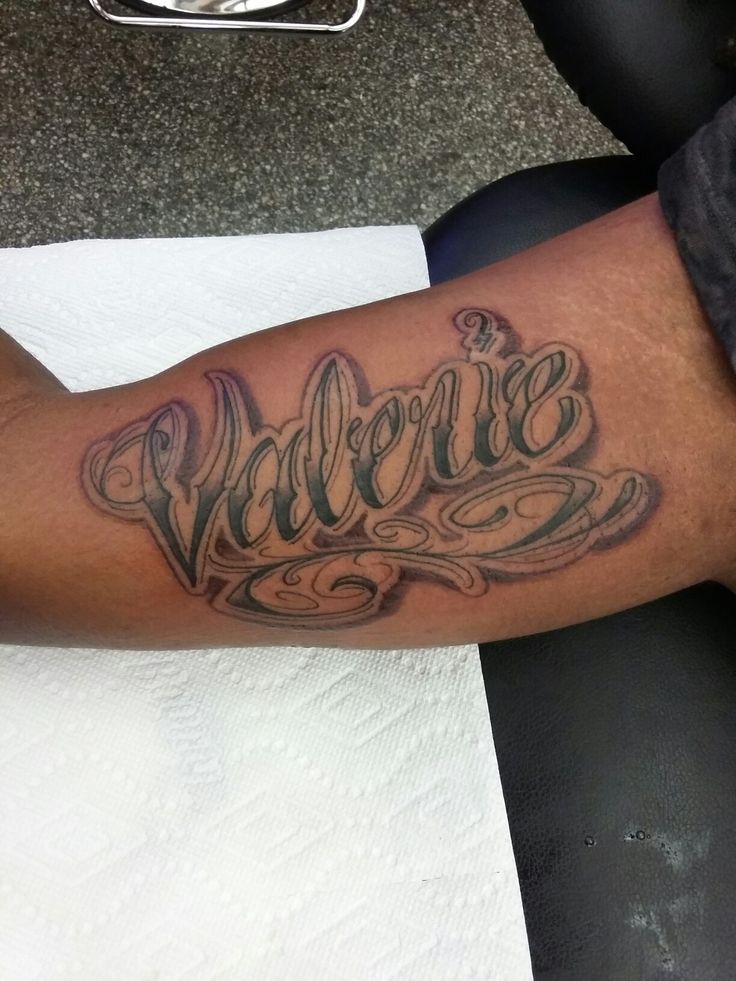 a man with a tattoo on his arm that says welcome in cursive writing