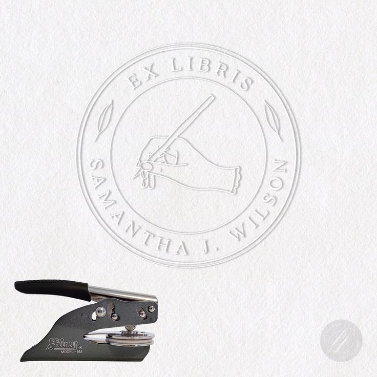 a pair of scissors are on top of a white piece of paper that says ex libris sannata wilson