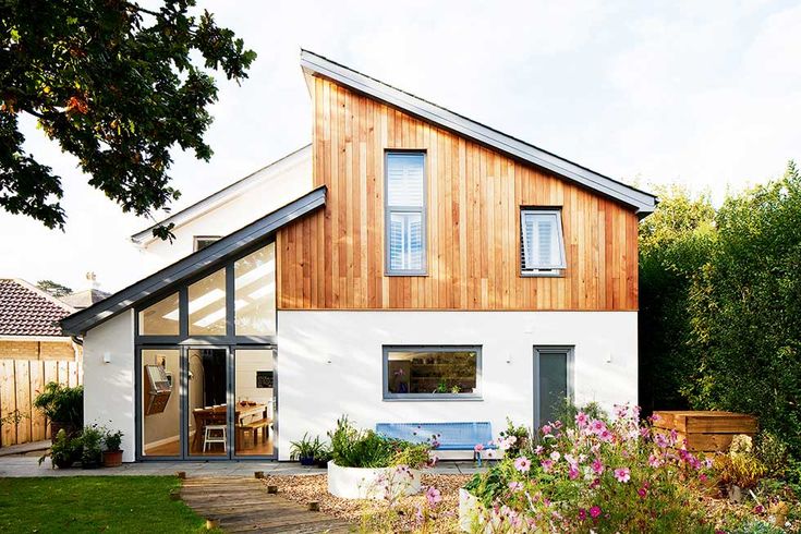 a white house with wooden siding and windows