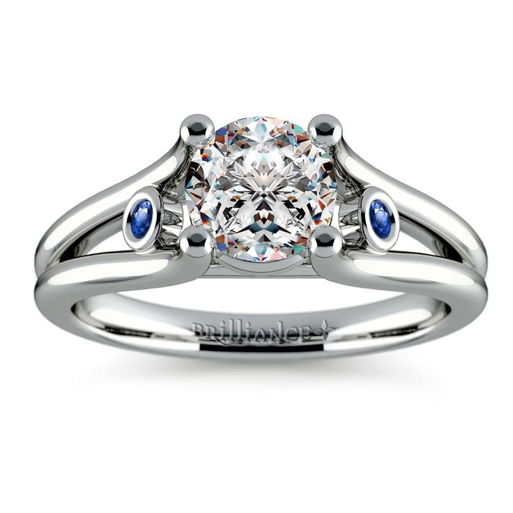 a white gold ring with an assorted cut diamond