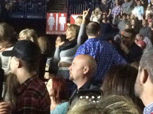 a group of people sitting next to each other in front of a crowd at a convention