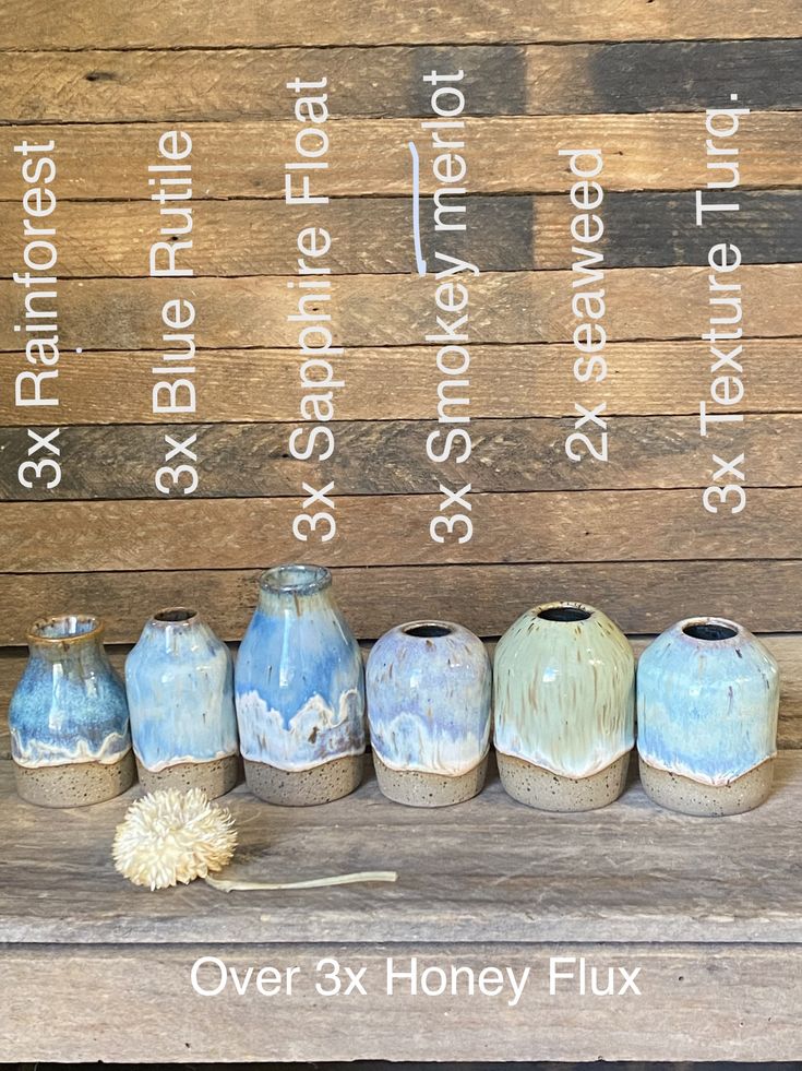 seven vases are lined up on a wooden bench with the words over 3x honey flux