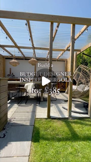 an outdoor patio area with wooden pergola and chairs on the grass, in front of