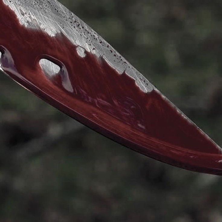 a close up of a knife being held in the air