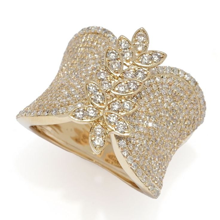 a gold ring with white diamonds on it's sides and a leaf design in the middle