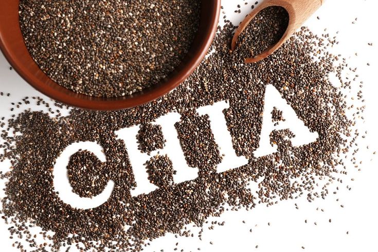 chia seeds in a bowl with the word chia spelled out on it next to a wooden spoon