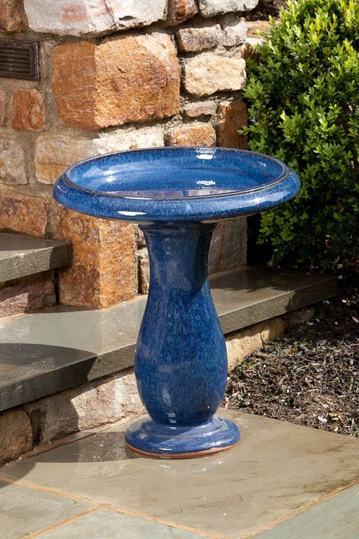 a blue vase sitting on top of a stone step