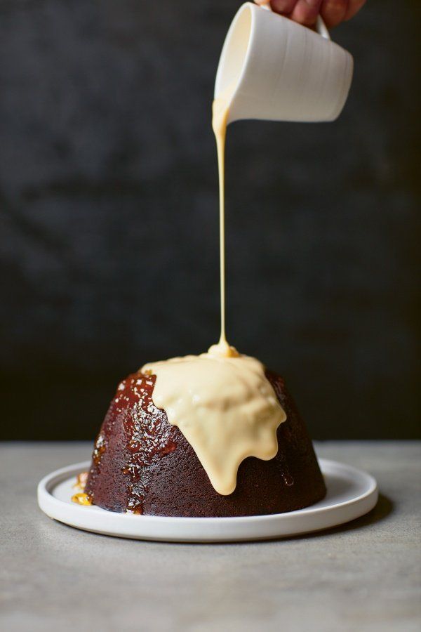 someone is pouring sauce on a bundt cake