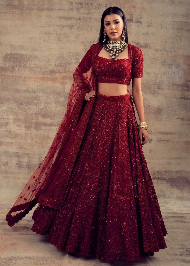 Feminine and flirty - Deep Red color lehenga is must-have attire for your wardrobe- Gulbarg! Who doesn't want to be trendy and fashion-forward in their special ceremonies? If you are one of them, we have got you covered. Show the world your gorgeous side as you dolled up in this beautiful deep red lehenga. Light-weight, comfortable, dainty, frilly, and beautiful, this deep red lehenga is a perfect epitome of royalty and femininity. The maroon colour of this lehenga speaks of elegance and appeal. Maroon Red Lehenga, Deep Red Lengha Bridal, Deep Maroon Bridal Lehenga, Dark Red Lengha, Red Sangeet Lehenga, Single Colour Lehenga, Crimson Red Lehenga, Red Party Lehenga, Red Lehenga Aesthetic