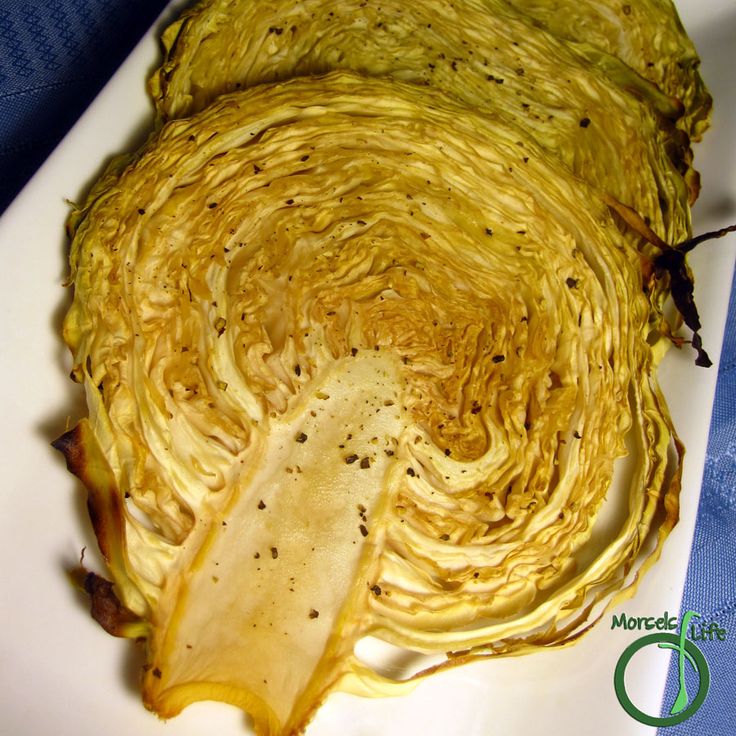 an artichoke is sitting on a white plate