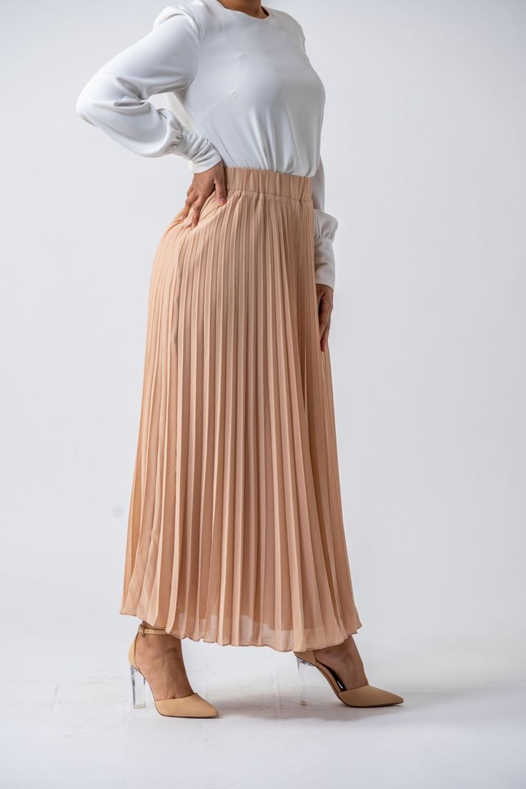 DESIGNED WITH YOU IN MIND You’ll never go wrong with a timeless maxi skirt. The chiffon material and soft hue make this a design that you can dress up or down. Tuck in a white tee and slip on flats or sneakers one day or accompany it with heels and a ruffled blouse on another. On another, you can accompany it with heels and a ruffled blouse. Perfect for all-day wear, we are sure youʼll love this womenʼs full-length skirt just as much as we do. Purchase yours from Ameera Modest Wear today! Specif Elegant Maxi Skirt For Day Out, Beige Flowy Maxi Skirt, Beige Flowy Maxi Skirt With Lining, Modest Pleated Maxi Skirt, Modest Maxi Skirt For Day Out, Beige Long Chiffon Skirt, Long Beige Chiffon Skirt, Elegant Beige Chiffon Skirt, Elegant Flowy Maxi Skirt For Day Out