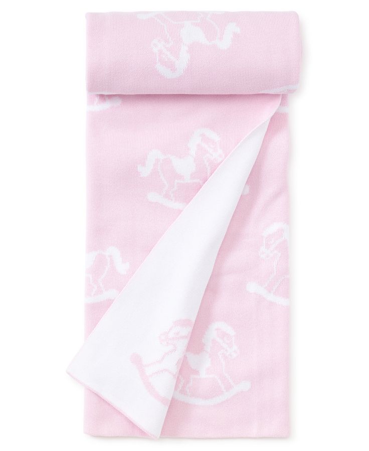 a pink and white blanket with horses on it