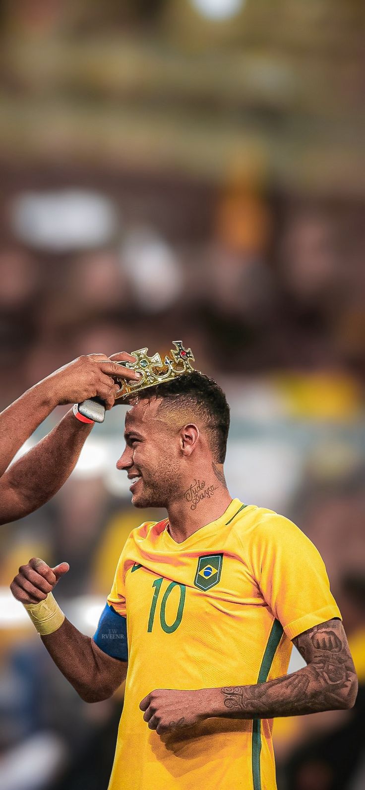 a man with a crown on top of his head is being fitted for a soccer game