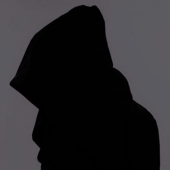 the silhouette of a person wearing a hoodie is shown against a gray background,