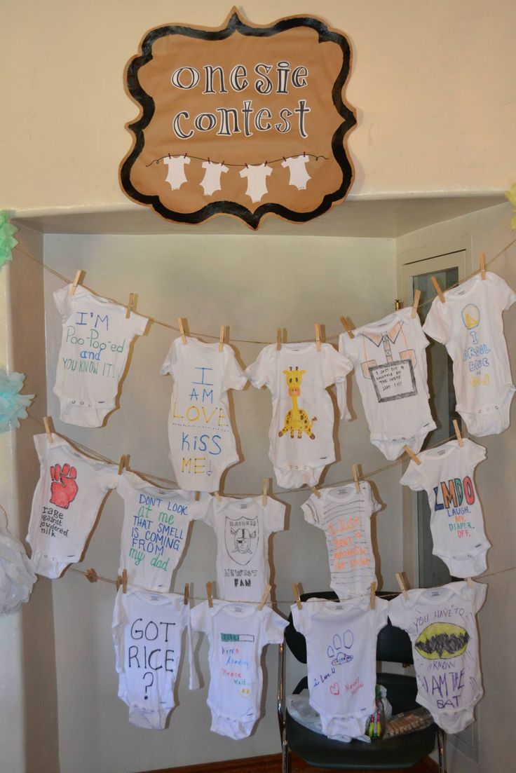 a baby's first birthday party with clothes hanging from the line