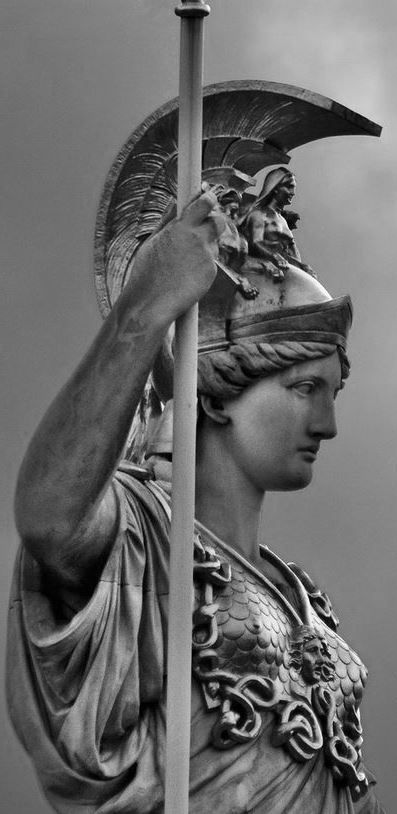 a black and white photo of a statue holding a pole with a flag on it