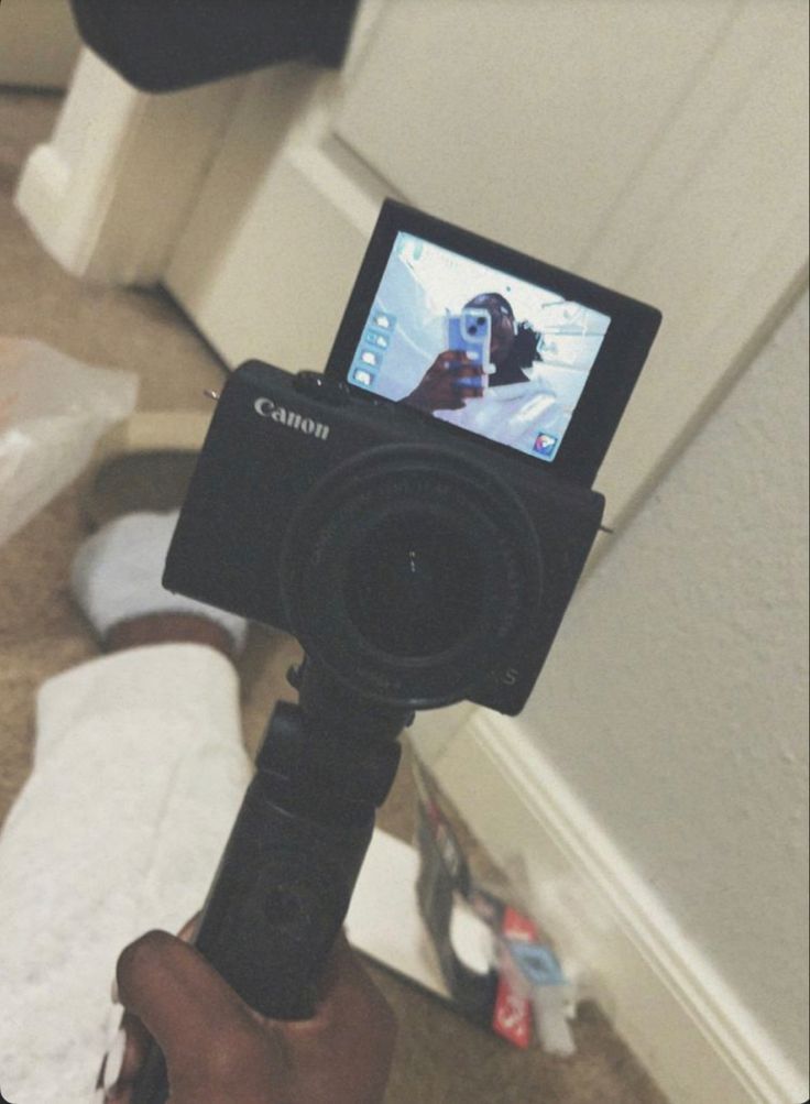 a person holding up a camera to take a photo