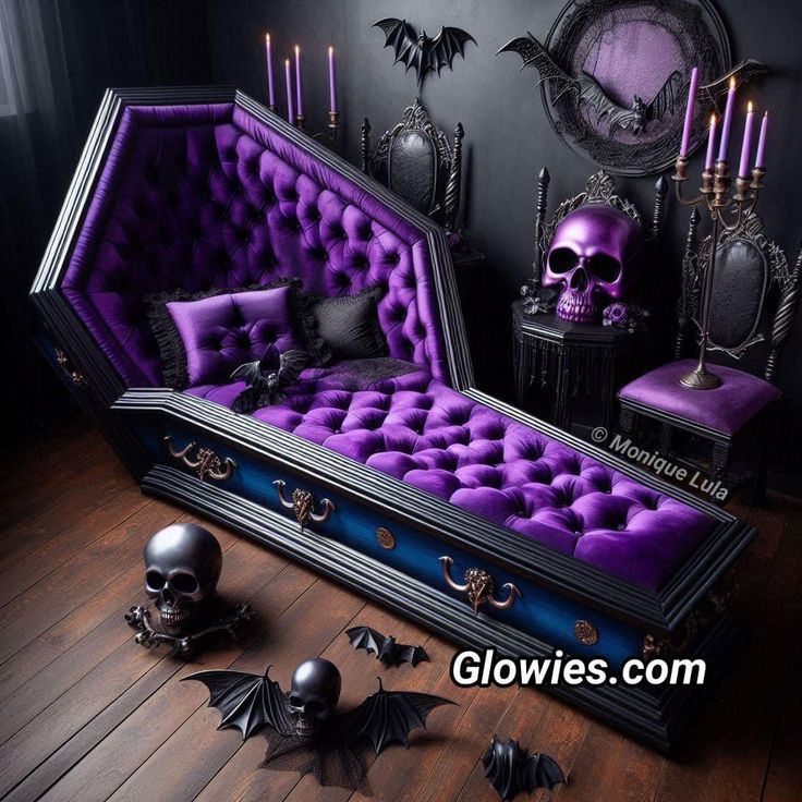 a purple couch sitting on top of a wooden floor next to two candles and skulls