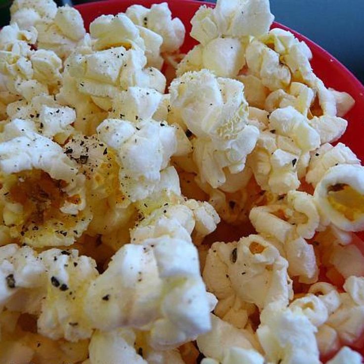 a red bowl filled with cauliflower on top of a table