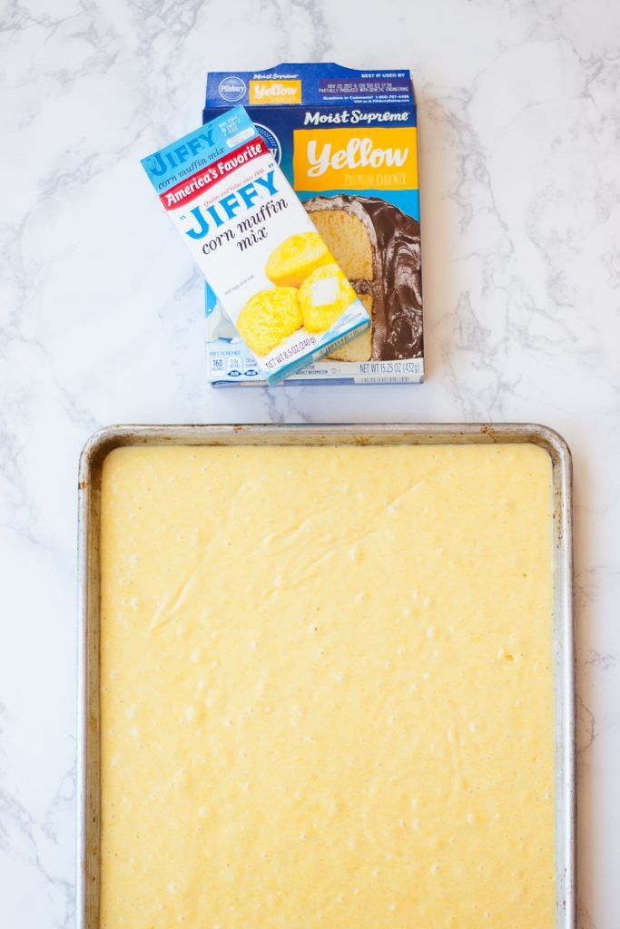 an uncooked cake in a pan next to a package of butter