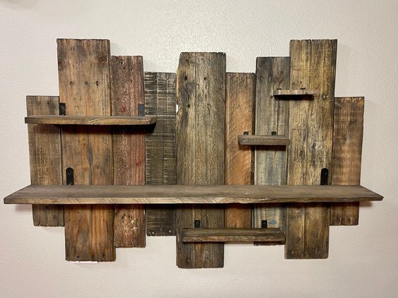 a shelf made out of wooden planks on the wall