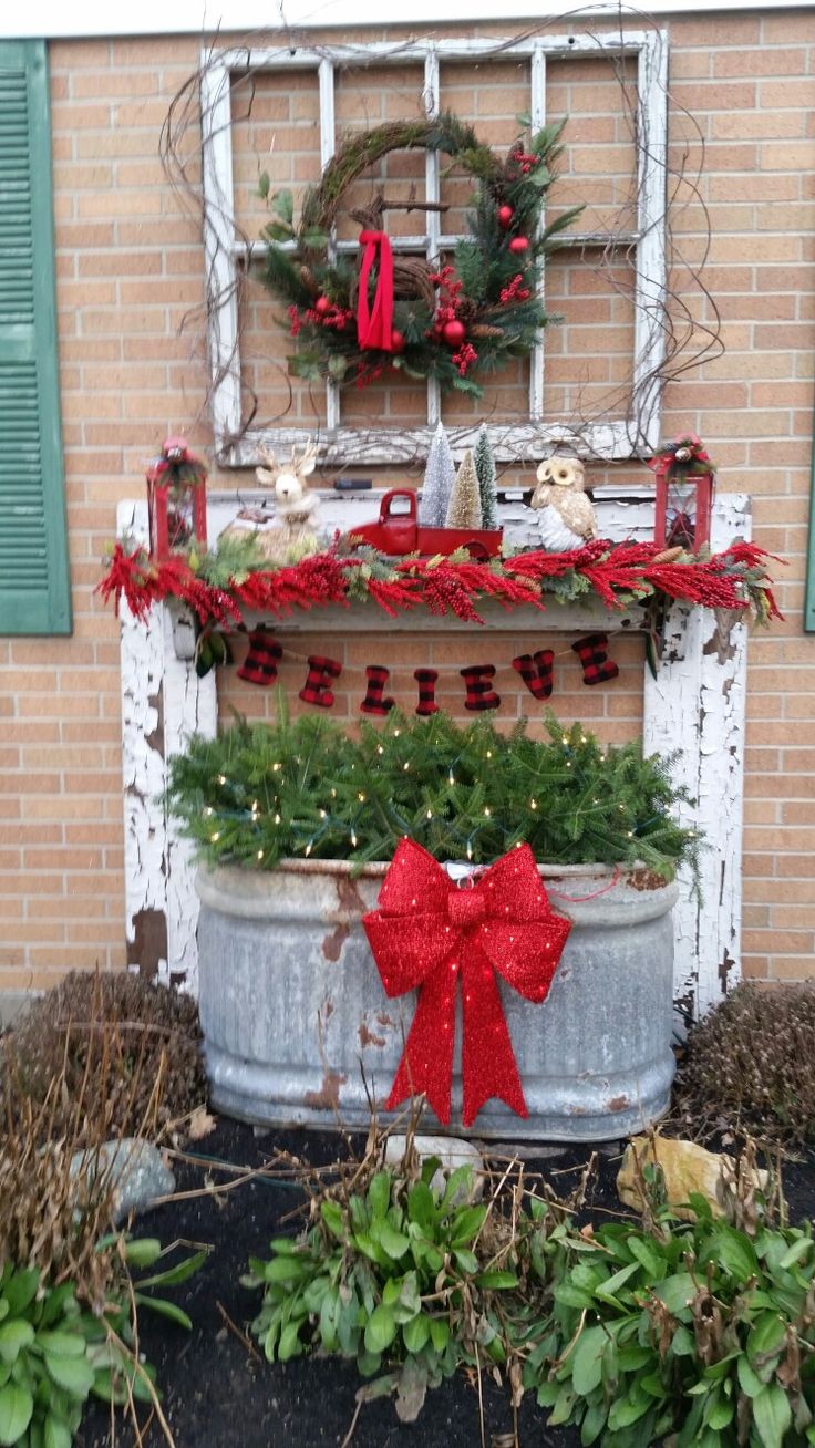 an old window is decorated with christmas decorations