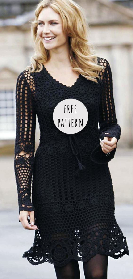 a woman walking down the street wearing a black dress with a free pattern on it