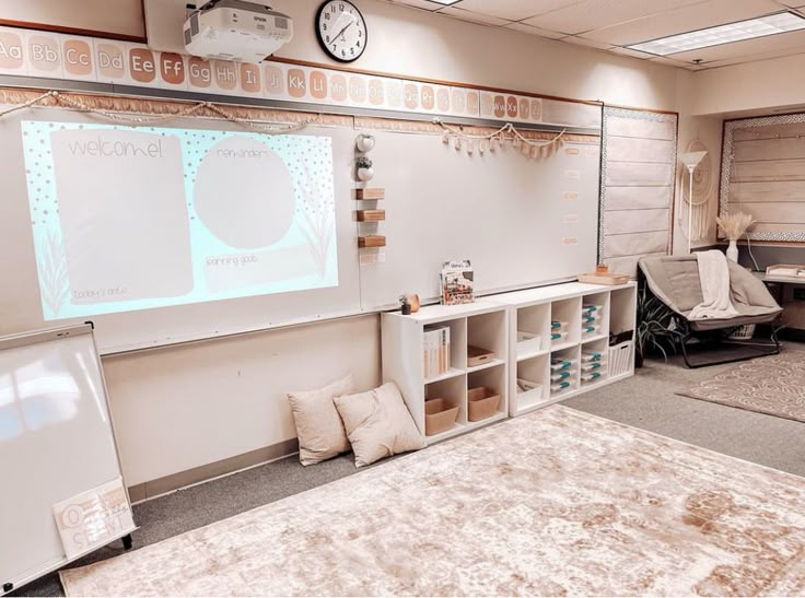 a room with a projector screen and several chairs