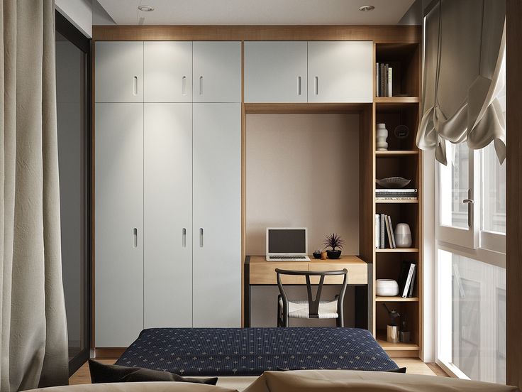 a bedroom with a bed, desk and cabinets