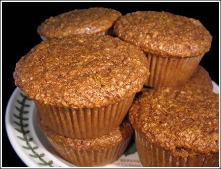 three muffins sitting on top of a white plate