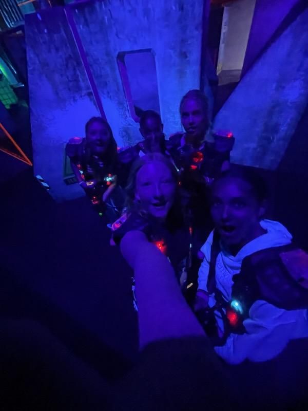 a group of people taking a selfie in the dark