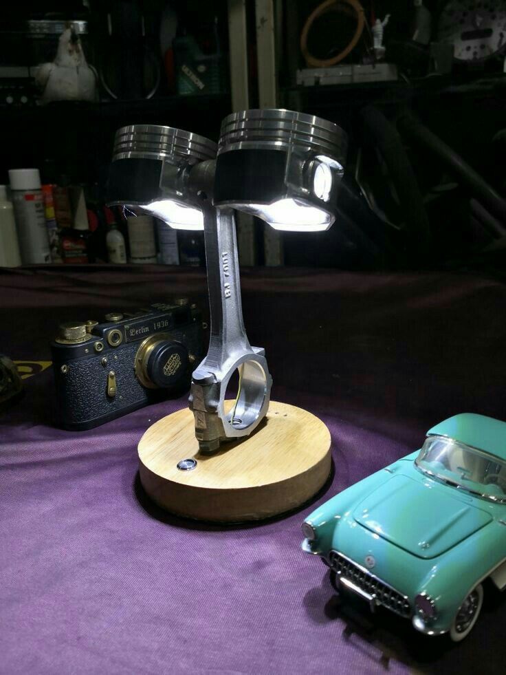 a toy car is sitting next to a lamp