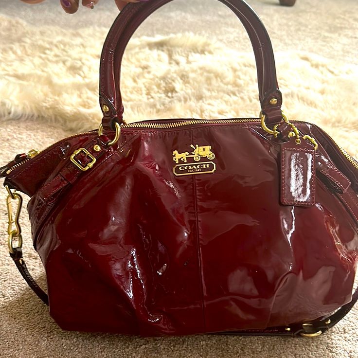 Coach Red Patent Leather Handbag. 2 Unnoticeable Stain Areas As Pictured. Gently Used. Designer Burgundy Bag With Detachable Strap, Designer Burgundy Bag With Handles, Coach Burgundy Shoulder Bag With Gold-tone Hardware, Designer Coach Bag In Burgundy, Burgundy Travel Bags With Gold-tone Hardware, Designer Burgundy Coach Bag, Red On-the-go Satchel With Double Handle, Red Coach Satchel, Designer Coach Shoulder Bag In Burgundy