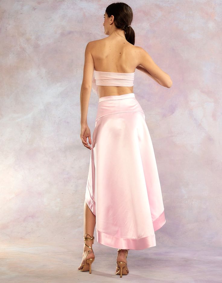 Light pink satin high low skirt. Hi-low hem Side invisible zipper High waisted Fabric content: 100% polyester Care instructions: dry clean only Fit: model is 5'9" and wears a size 2. Size 2 measurements: Length in front: 20" Full length: 41'' Complete the look: Organza Flower Bandeau Spring Pink Satin Bottoms, Pink Satin Skirt For Spring, Pink Lined Skirt Bottoms For Evening, Pink Satin Evening Bottoms, Pink Silk Maxi Skirt For Spring, Spring Pink Silk Maxi Skirt, Pink Satin Skirt For Party, Pink Satin Party Skirt, Pink Satin Lined Skirt Bottoms