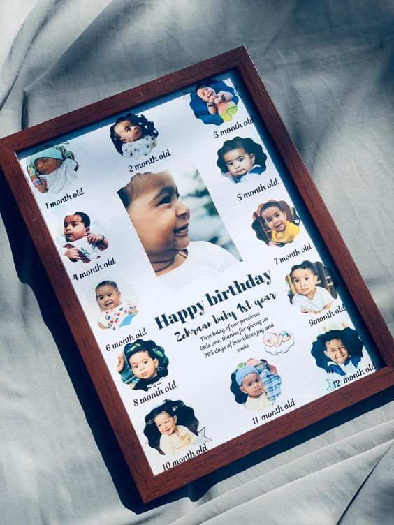 a wooden frame with pictures of babies on it, and the words happy birthday written in cursive writing