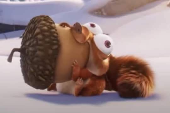 a squirrel and an owl are in the snow with one being hugged by another animal