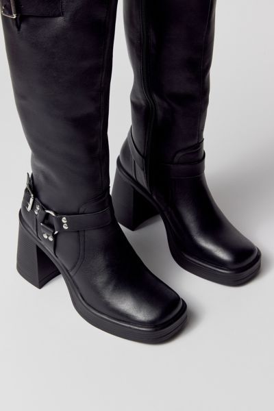 Motorcycle boots from Steve Madden. Tall silhouette in premium leather topped with minimalist moto detailing. Squared toe with a high block heel. Features Steve Madden moto boots Soft leather with moto detailing Zip closure Content + Care Leather, rubber Spot clean Imported Size + Fit Shaft: 13.75" h; 14" circ Heel: 3.5" h | Steve Madden Francine Moto Boot in Black, Women's at Urban Outfitters Trendy Leather Platform Boots With Square Toe, Trendy Leather Square Toe Platform Boots, Square Toe Moto Boots With Reinforced Heel For Workwear, Edgy Leather Heeled Boots With Lug Sole, Leather Knee-high Platform Moto Boots, Modern Leather Platform Boots With Block Heel, Knee-high Leather Platform Moto Boots, Leather Platform Boots With Stacked Heel And Square Toe, Leather Heeled Boots With Square Toe And Lug Sole