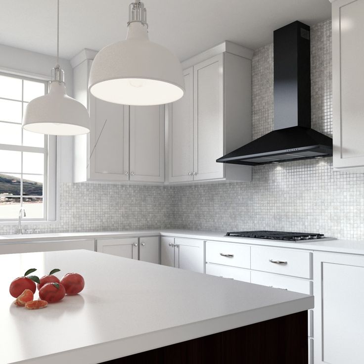 a kitchen with white cabinets and marble counter tops, two hanging lights over the island