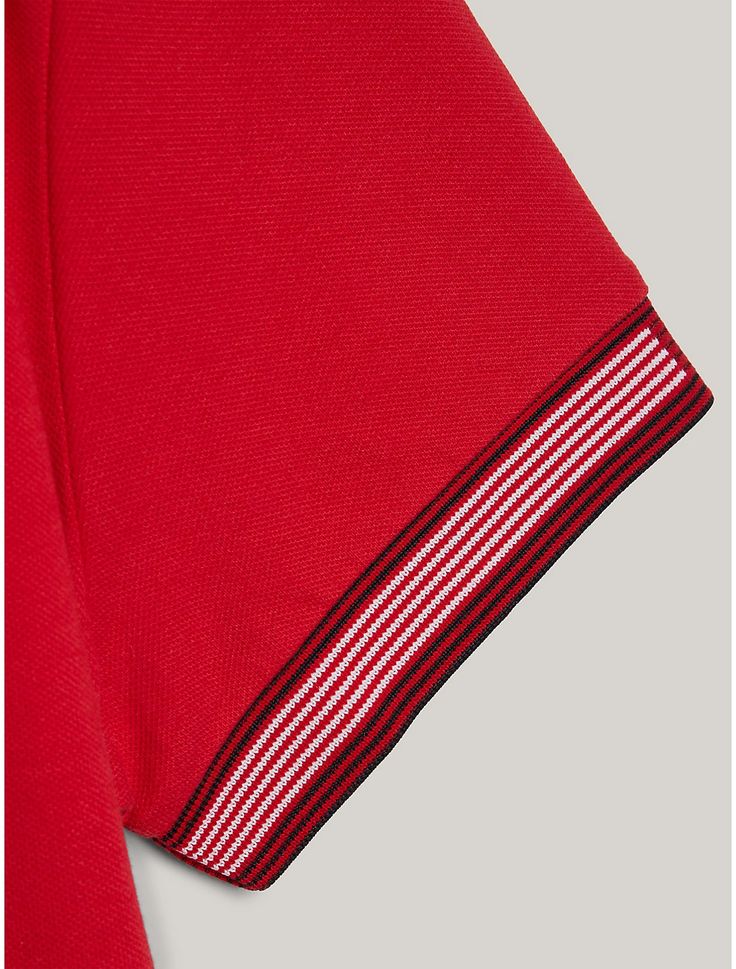 Tommy Hilfiger men's polo. Striking tipped cuffs add an elevated touch to this stretch pique polo, designed in a streamlined slim fit. Part of our Adaptive Collection, designed for ease of dressing in classic Tommy style.  Material: 67% Organic Cotton. Polo Shirt With Ribbed Cuffs For Workwear, Workwear Polo Shirt With Ribbed Cuffs, Classic Red Polo Shirt With Striped Collar, Modern Collared Top With Contrast Trim, Tommy Hilfiger Man, Men's Polo, Mens Polo, Tommy Hilfiger, Organic Cotton