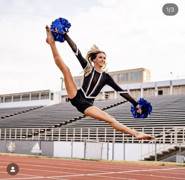 a cheerleader is jumping in the air with her pom poms