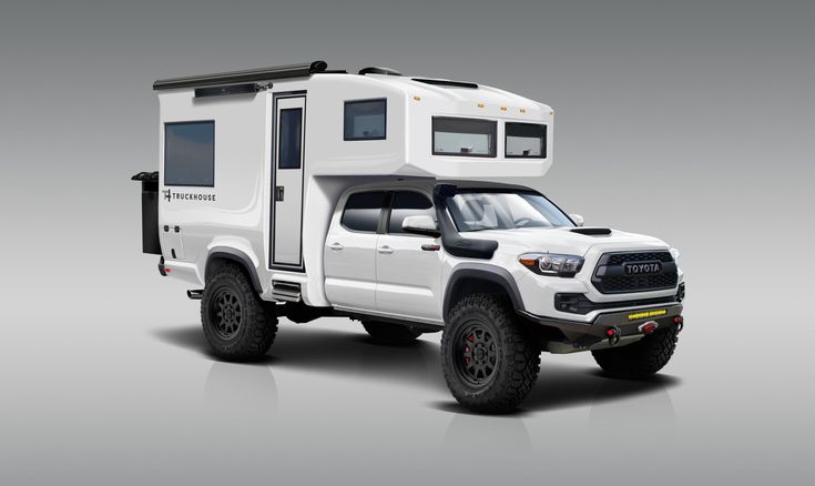 a white truck with a camper attached to it