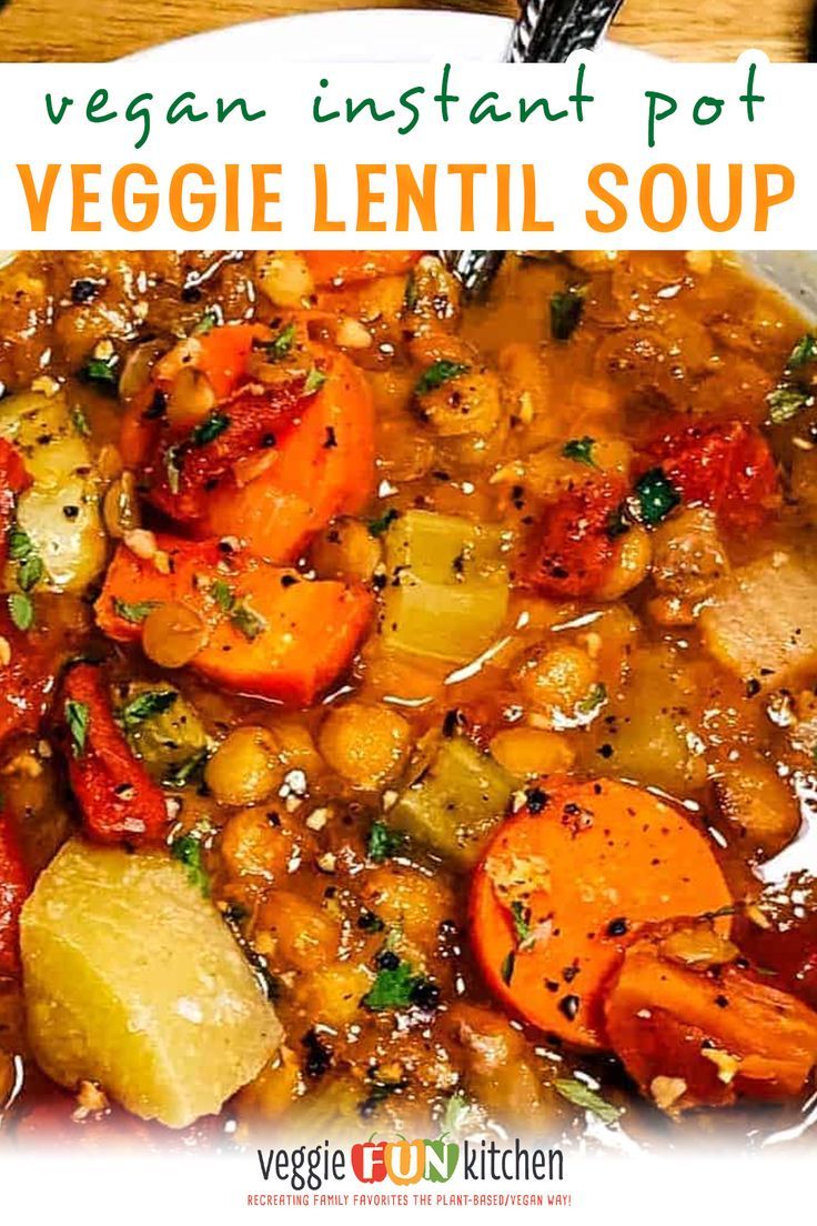 a bowl filled with vegetable lentil soup on top of a wooden table