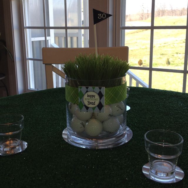 some golf balls are in a glass vase on a table