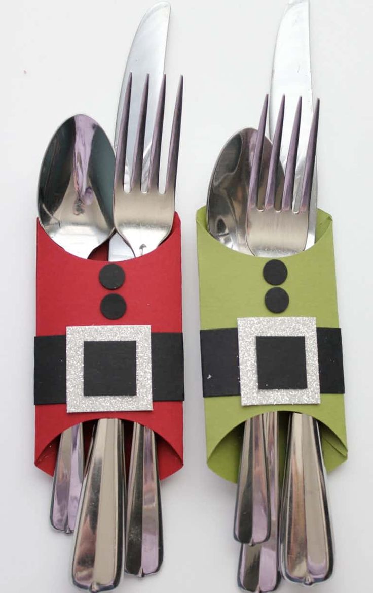 two forks and spoons decorated like santa claus