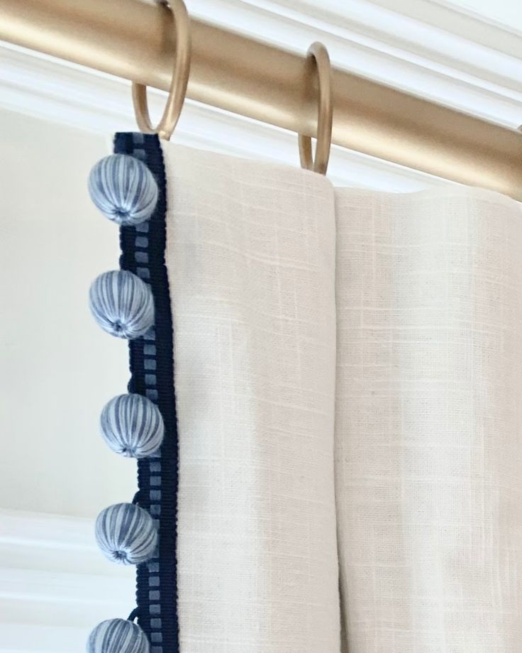 a curtain with tassels hanging from it's side