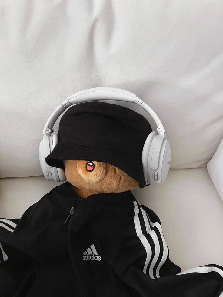 a teddy bear wearing headphones on top of a couch