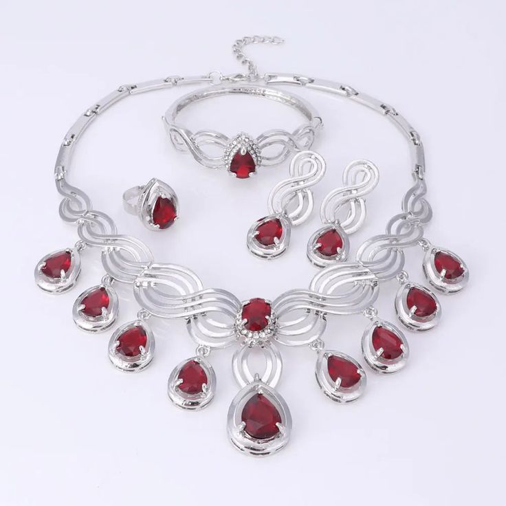 Elegant Crystal Statement Necklace Set Red Party Jewelry With Jewels, Ruby Jewelry Sets For Party, Elegant Christmas Formal Jewelry, Elegant Christmas Jewelry For Formal Occasions, Christmas Party Jewelry With Cubic Zirconia, Red Metal Jewelry Sets For Party, Red Crystal Jewelry For Party, Red Crystal Party Jewelry, Crystal Jewelry For Christmas Party