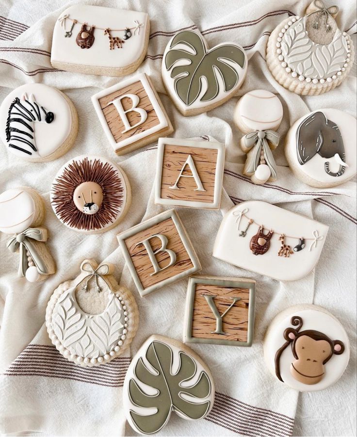 baby cookies are laid out on a bed with the letters and animals spelled in them