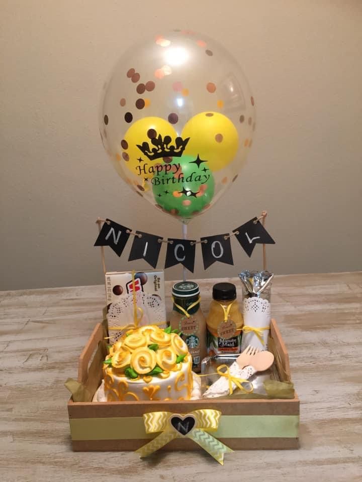 a birthday gift box with balloons, confetti and other items for someone's special occasion