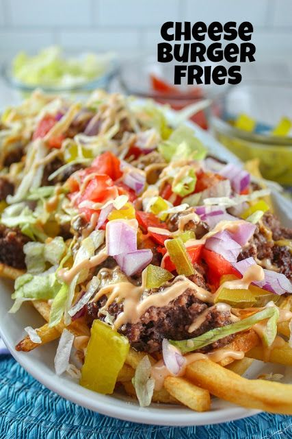 cheeseburger fries on a white plate with lettuce, tomatoes and onions